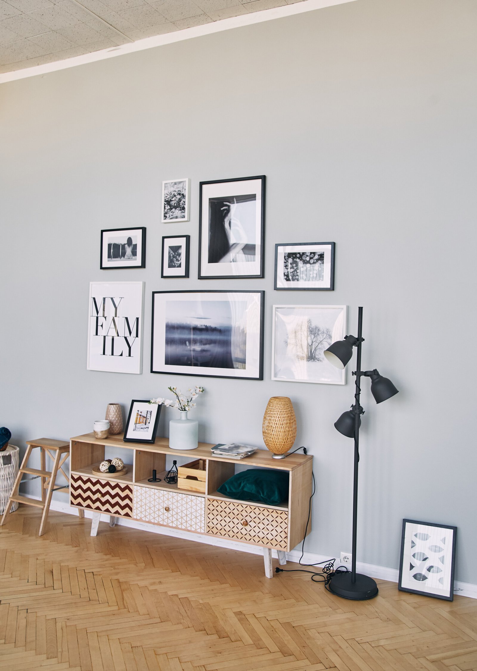 different size framed photos hanging on the gray wall.